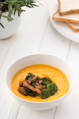 Delicious cream soup on a white table.. Homemade creamy cheese soup. Potato and chicken cream soup. Close up view. Space for text