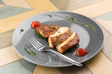 Grilled chicken breast. Roasted Chicken with Vegetables served on a grey plate.