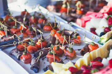 Beautiful different colored decorated candy table baked sweet tasty cupcake cupcakes on a party, beautifully decorated catering banquet table with different candy sweet delicacy