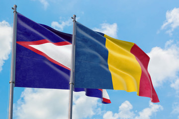 Chad and American Samoa flags waving in the wind against white cloudy blue sky together. Diplomacy concept, international relations.