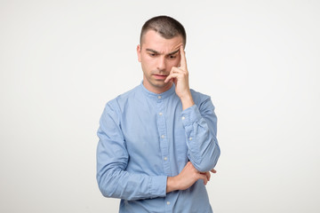 Hispanic young man thinking about idea or making a choice.