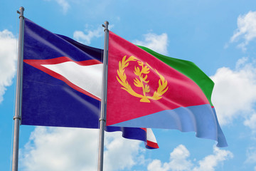 Eritrea and American Samoa flags waving in the wind against white cloudy blue sky together. Diplomacy concept, international relations.