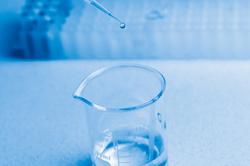 Synthesis of new vaccine or medicine against coronavirus. Clinical laboratory in process of chemical analysis. Collection of probe using automatic pipette.