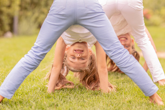 young girls lying on grass in park
