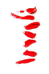 Texture of classic red lipstick on a white background close-up.