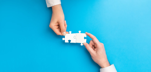 People holds in hand a jigsaw puzzle. Business solutions, success and strategy.