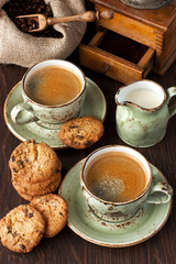 Still life with vanilla  cookies and coffee cup ,  old coffee grinder on wooden table