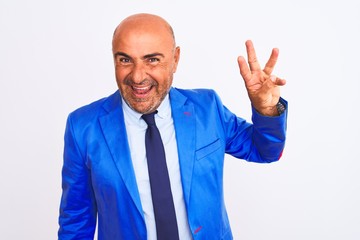 Middle age businessman wearing suit standing over isolated white background showing and pointing up with fingers number three while smiling confident and happy.