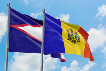 Moldova and American Samoa flags waving in the wind against white cloudy blue sky together. Diplomacy concept, international relations.