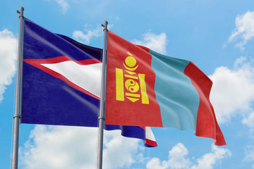 Mongolia and American Samoa flags waving in the wind against white cloudy blue sky together. Diplomacy concept, international relations.