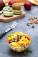 Fresh fruits salad - mango, citrus, kiwi fruit, plum and persimmon. Healthy food. Smoothie mix.