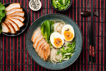 Asian Noodle Soup Ramen With Chicken And Egg Served In Bowl On Bamboo Mat. Top View