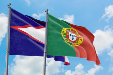 Portugal and American Samoa flags waving in the wind against white cloudy blue sky together. Diplomacy concept, international relations.