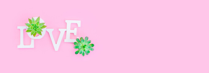 Word love from white volume letters on pink background