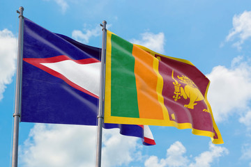 Sri Lanka and American Samoa flags waving in the wind against white cloudy blue sky together. Diplomacy concept, international relations.