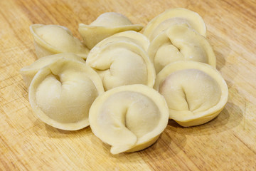 Traditional Russian dumplings hand-made on a cutting Board.