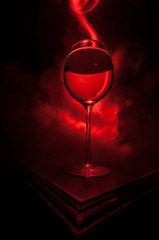 Goblet of white wine on wooden table on wooden wall background