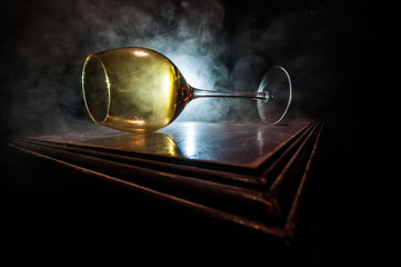 Goblet of white wine on wooden table on wooden wall background