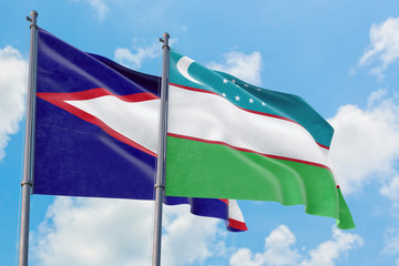 Uzbekistan and American Samoa flags waving in the wind against white cloudy blue sky together. Diplomacy concept, international relations.