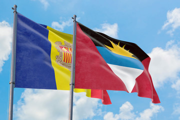 Antigua and Barbuda and Andorra flags waving in the wind against white cloudy blue sky together. Diplomacy concept, international relations.