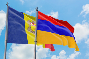 Armenia and Andorra flags waving in the wind against white cloudy blue sky together. Diplomacy concept, international relations.