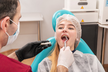 Doctor pulls a tooth of the patient