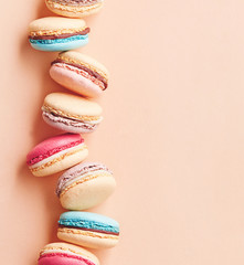 Macarons on colored background. Sweet and colourful french macaroons. Composition of macarons
