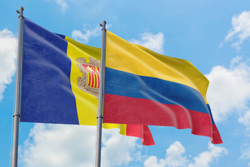 Colombia and Andorra flags waving in the wind against white cloudy blue sky together. Diplomacy concept, international relations.