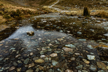 coloured pebbles showing through water, trassey track, Mournes, County Down, Northern Ireland