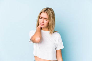 Young blonde caucasian woman isolated having a neck pain due to stress, massaging and touching it with hand.