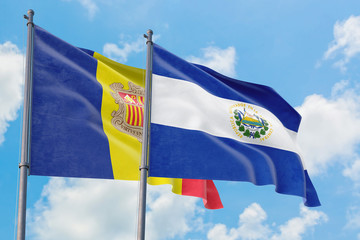 El Salvador and Andorra flags waving in the wind against white cloudy blue sky together. Diplomacy concept, international relations.