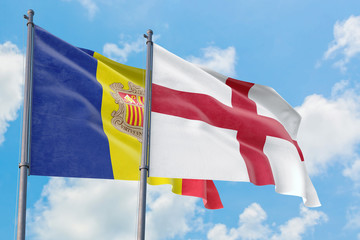 England and Andorra flags waving in the wind against white cloudy blue sky together. Diplomacy concept, international relations.
