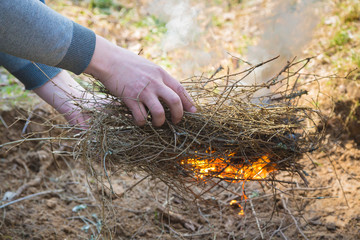 Safely lighting a fire in the forest countryside