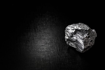 big big silver nugget on black background. Raw silver stone, silver nugget native to Liberia, isolated on black background. Mineral extraction.