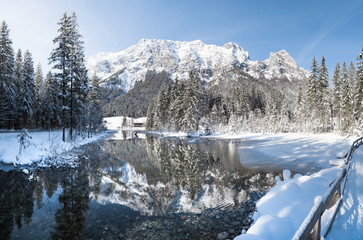 Idyllic winter wonderland with mountain lake in the Alps