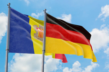 Germany and Andorra flags waving in the wind against white cloudy blue sky together. Diplomacy concept, international relations.