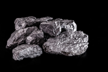 large silver nugget on black background. Raw silver stone, silver nugget native to Liberia, isolated on black background. Mineral extraction.