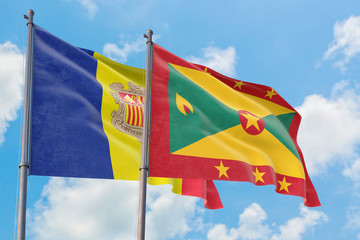 Grenada and Andorra flags waving in the wind against white cloudy blue sky together. Diplomacy concept, international relations.