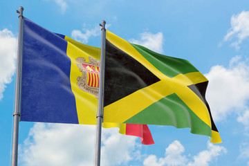 Jamaica and Andorra flags waving in the wind against white cloudy blue sky together. Diplomacy concept, international relations.