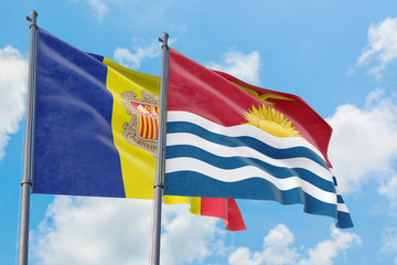 Kiribati and Andorra flags waving in the wind against white cloudy blue sky together. Diplomacy concept, international relations.