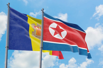 North Korea and Andorra flags waving in the wind against white cloudy blue sky together. Diplomacy concept, international relations.
