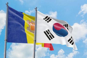 South Korea and Andorra flags waving in the wind against white cloudy blue sky together. Diplomacy concept, international relations.