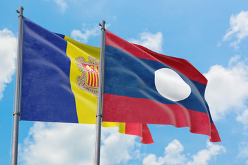 Laos and Andorra flags waving in the wind against white cloudy blue sky together. Diplomacy concept, international relations.