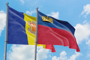 Liechtenstein and Andorra flags waving in the wind against white cloudy blue sky together. Diplomacy concept, international relations.