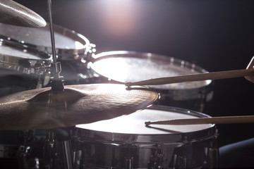 The man is playing drum set