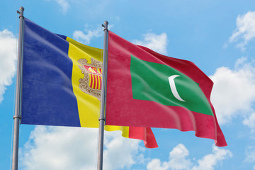 Maldives and Andorra flags waving in the wind against white cloudy blue sky together. Diplomacy concept, international relations.