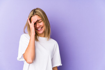 Young blonde caucasian woman isolated laughing happy, carefree, natural emotion.