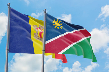 Namibia and Andorra flags waving in the wind against white cloudy blue sky together. Diplomacy concept, international relations.