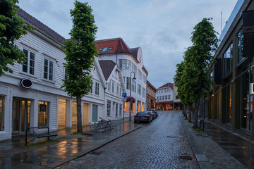 STAVANGER, NORWAY, july, 2019 : street with Traditional wooden houses in Gamle Stavanger. Gamle Stavanger is a historic area of the city center of Stavanger. Rainy moody day.