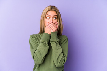 Young blonde caucasian woman isolated shocked covering mouth with hands.